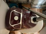 a vacuum that is sitting on the floor next to a canister
