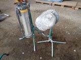 a metal object that is sitting on a stand in the dirt