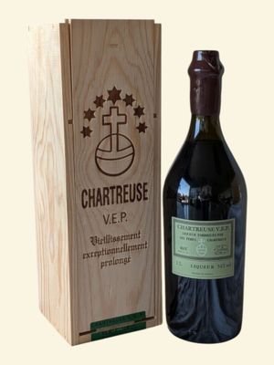 a bottle of wine in front of a wooden box