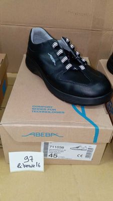 two pairs of shoes that are on top of a box