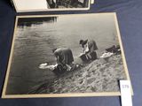 two old black and white photos of people washing clothes in a river