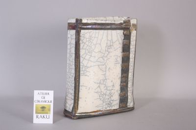 a small box with a map on it next to a book