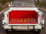 a red and white truck parked on the side of the road