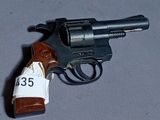 a toy gun with a tag on it sitting on a table