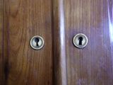 a close up of a wooden door with a keyhole