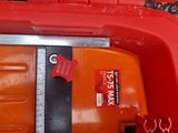 a red toy car with a measuring tape on the side of it