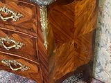 a marble top chest of drawers in a room