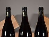 three bottles of wine sitting next to each other on a table
