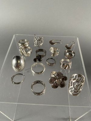 a clear display case with a lot of rings on it