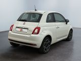 the back of a white fiat car parked in a white room