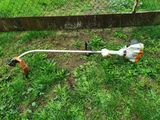 an image of a lawn mower that is in the grass