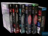 a lot of dvds that are stacked on top of each other