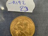 a close up of a gold coin with a label on it