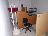 a desk with a chair and a lamp in a room