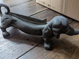 une petite statuette représentant un teckel posée sur un parquet