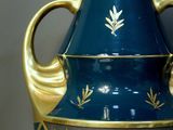 a blue and gold vase sitting on a table