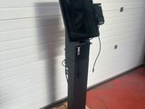 an image of a television on a stand in a garage