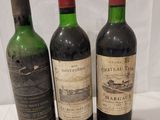 three bottles of wine are lined up on a table