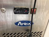 a stainless steel freezer with a blue and white logo on it