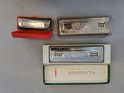 trois harmonicas posées sur une table
