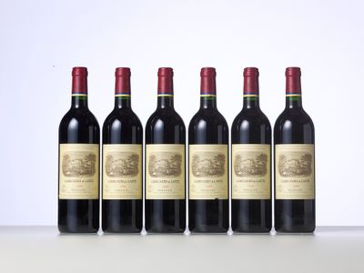 six bottles of red wine lined up in a row