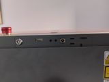 a close up of a laptop with a red button on it