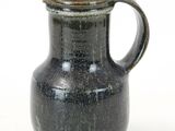 a black vase with a handle on a white background