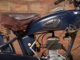 a motorcycle that is parked in front of a brick wall
