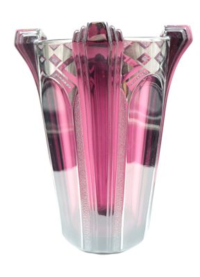 a pink vase that is sitting on a white surface