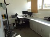 a desk with a chair and a computer on it