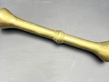 an old brass baseball bat sitting on top of a table