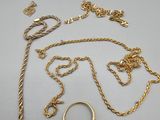 a collection of gold jewellery including rings, chains, and rings