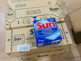 a box of sun soap sitting on top of a cardboard box