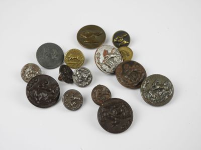 several different types of metal buttons on a white surface