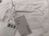 a close up of a pair of white pants with a tag on it