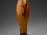 a vase that is sitting on a table with a gray background