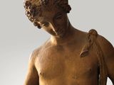 statue of a man holding a fish in his right hand