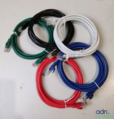 four different colored cables are connected to each other on a white surface
