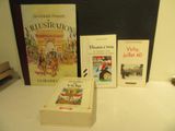 several books are sitting on a table in front of a blackboard