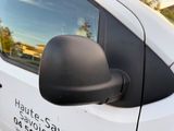 an image of a side view mirror of a white van