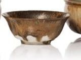 three bowls and a bowl sitting next to each other on a white surface