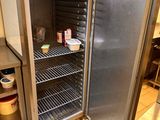 an open refrigerator in a kitchen with a lot of food in it