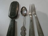 several spoons, forks, and spoon rest on a white surface