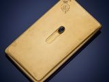 a gold plated nokia phone on a blue background