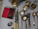 a lot of silver spoons and silverware on a table