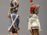 two figurines of a man and a woman on a table