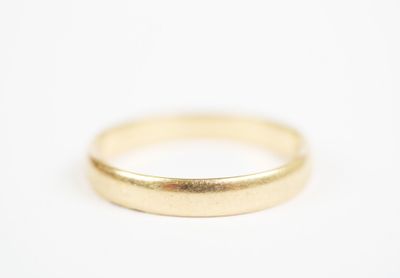 a close up of a gold ring on a white surface