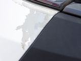 a close up of a car ' s hood with paint peeling off of it