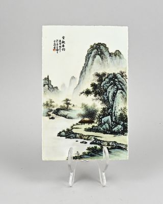 an oriental painting of a river and mountains on a small stand
