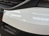 a close up of a car ' s grille with a clock on it